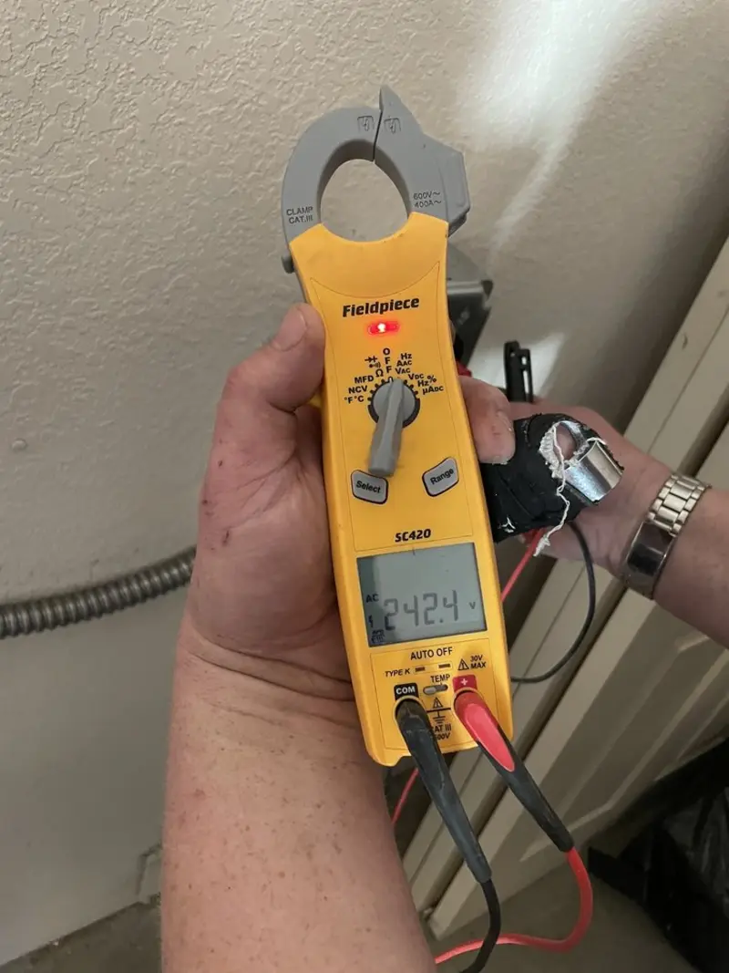 Voltage testing with clamp meter during Recessed Lighting Installation in Colon